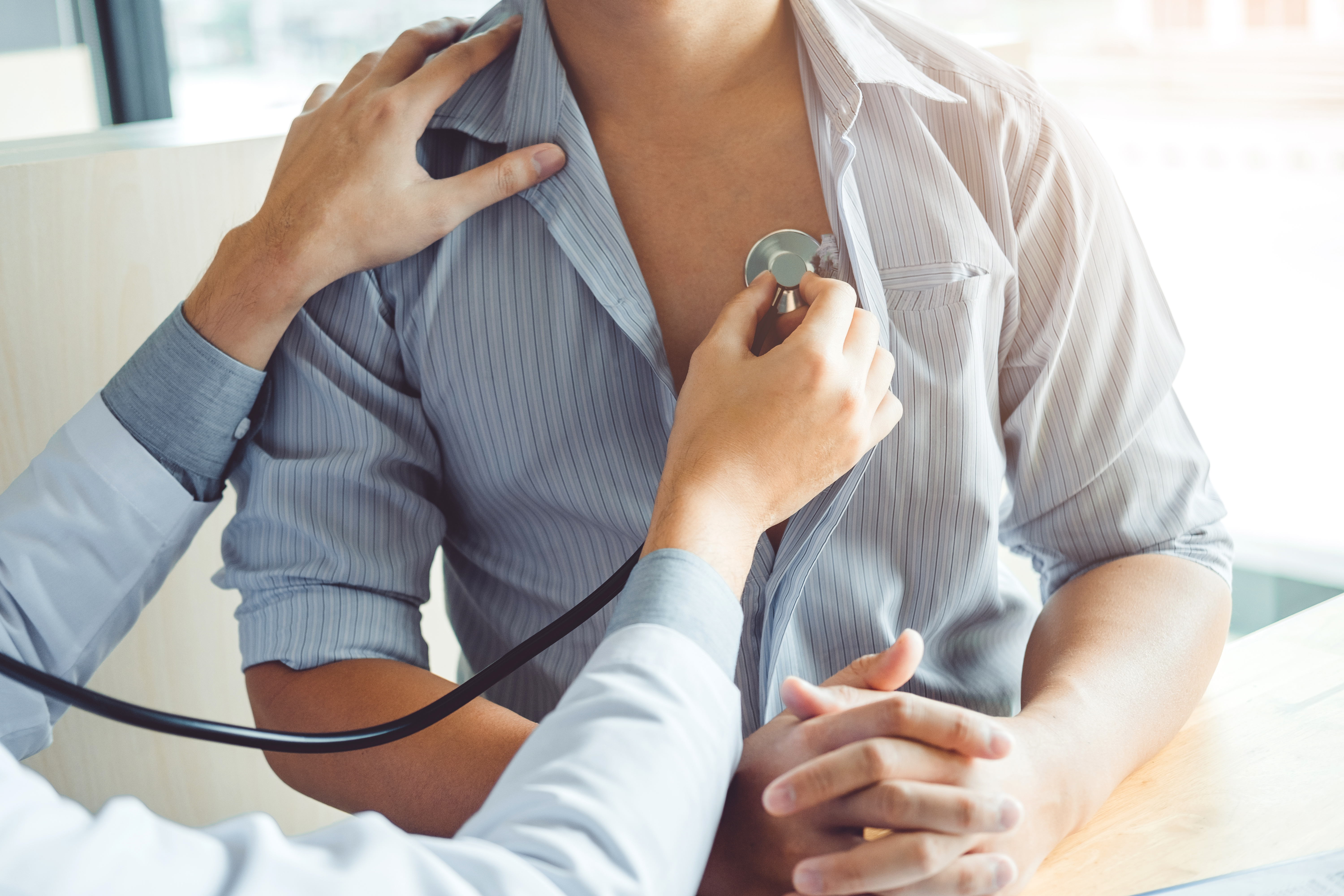 Clinician evaluating a patient’s heart function as part of a cardiac excellence program aligned with DNV CCED standards